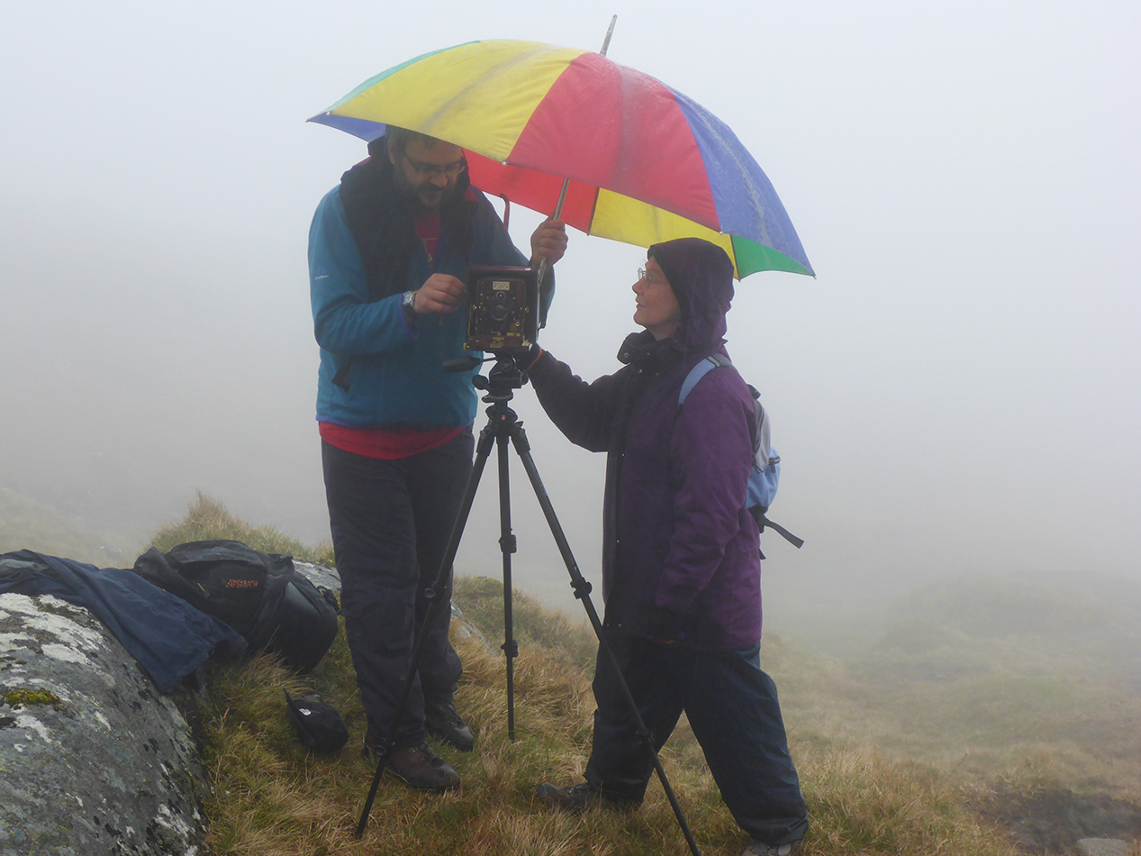 Setting up for a drizzly group photo.
