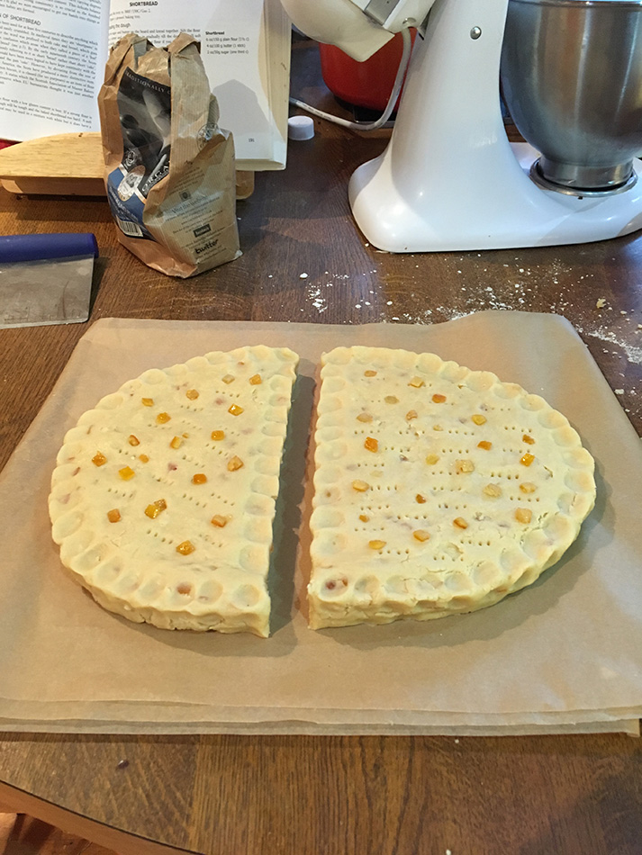 Pinch the edges, mark the top, strew with candied peel