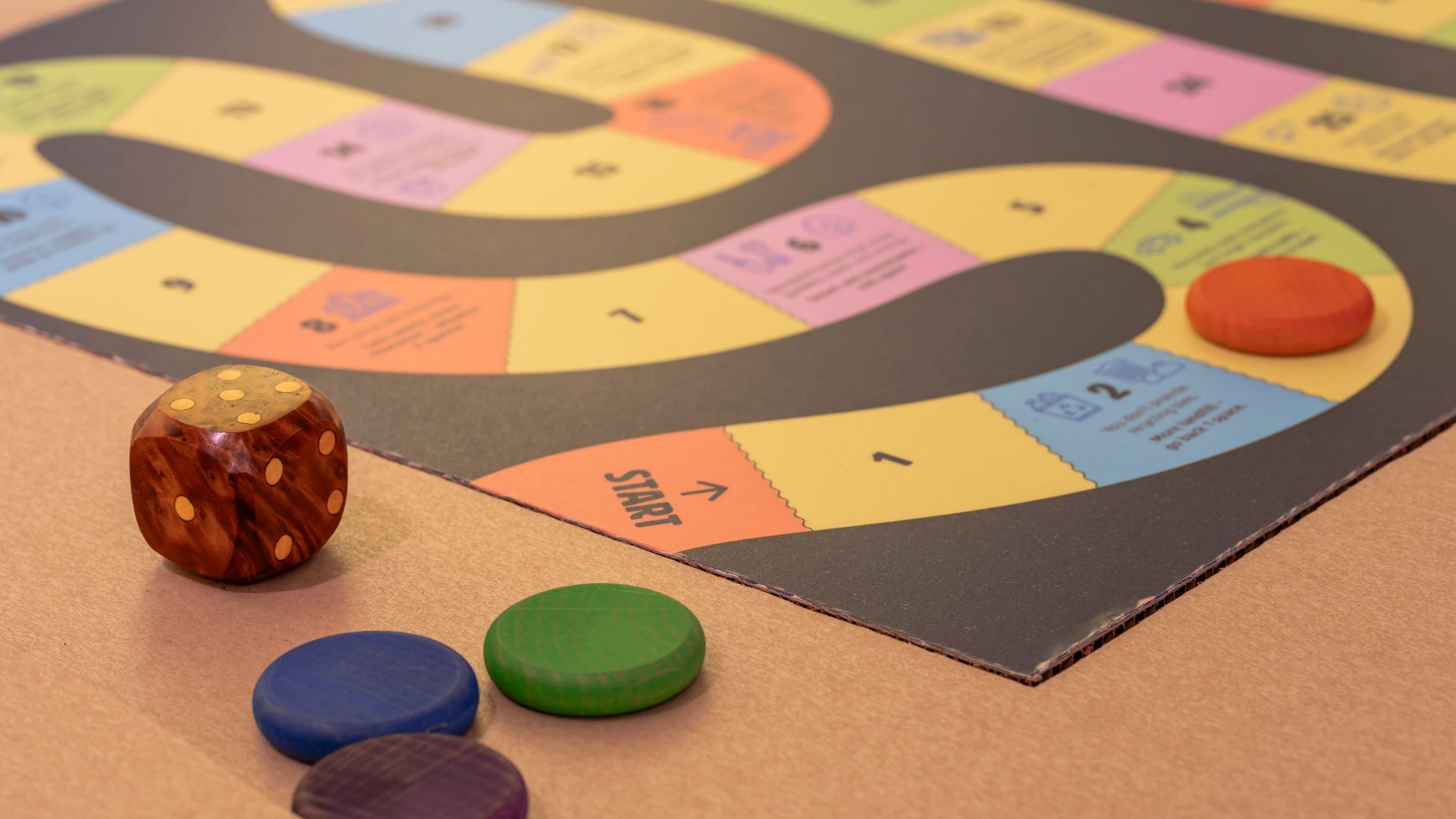 Board game and dice on a cardboard table