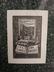 Image of book plate with illustration of books in front of an open window