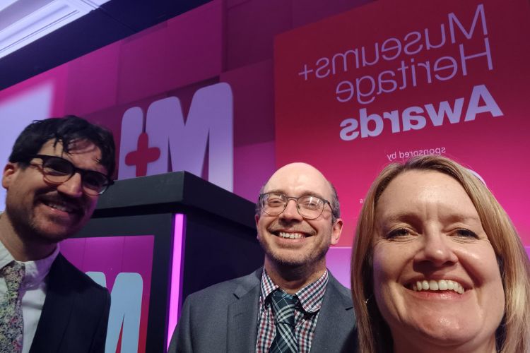 Three staff members smiling in a selfie.
