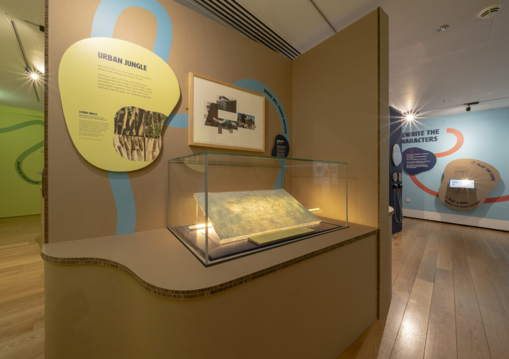 A gallery space with walls built with a cardboard-like material.